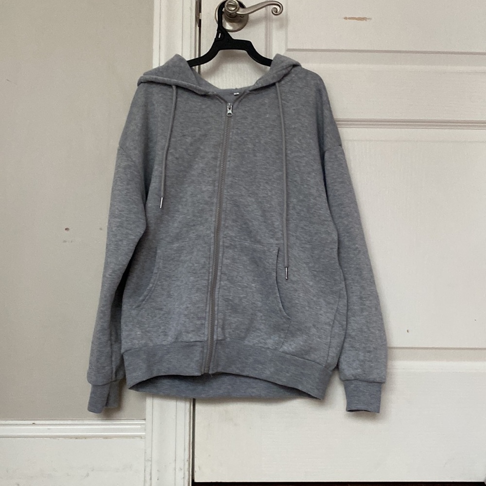 grey zip up jacket .